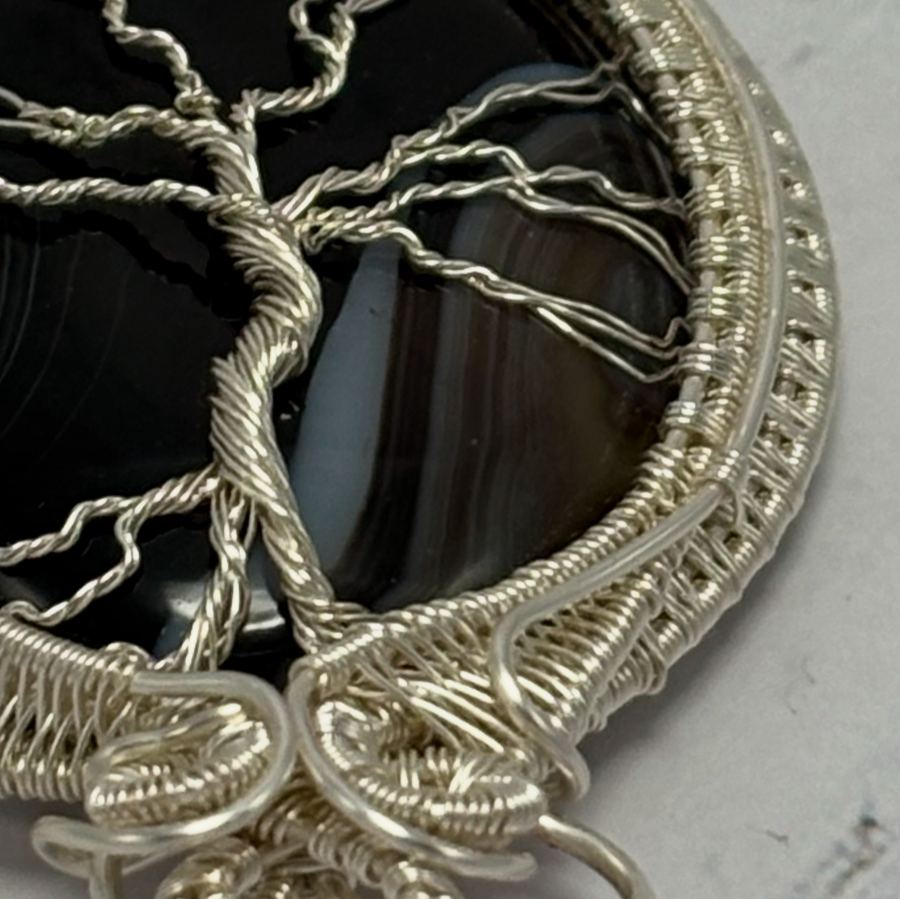 Close-up of the twisted silver wire branches of the Tree of Life pendant