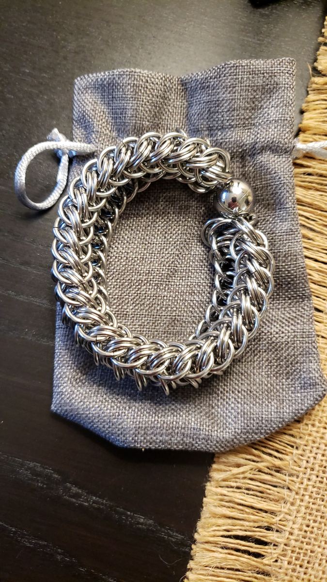 Large stainless steel chainmaille bracelet on a linen pouch